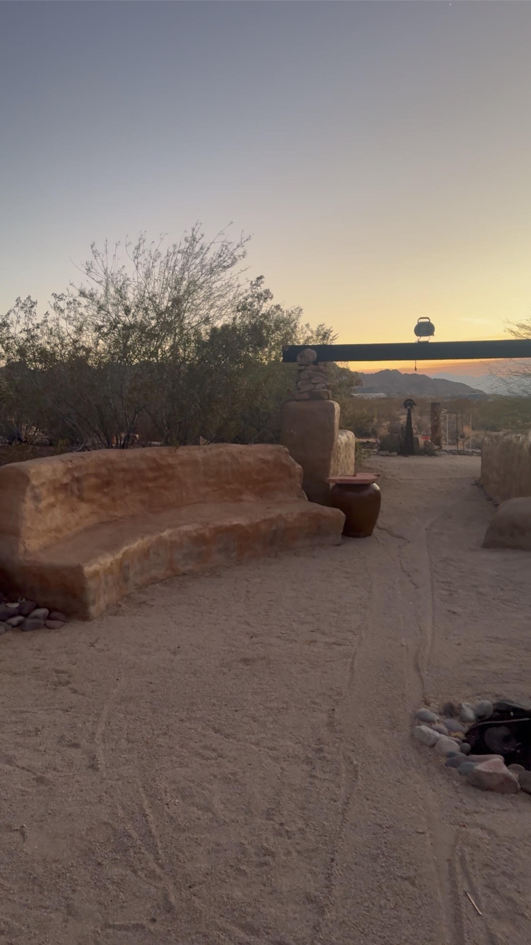 Adobe ceremony bench and fire circle at sunset