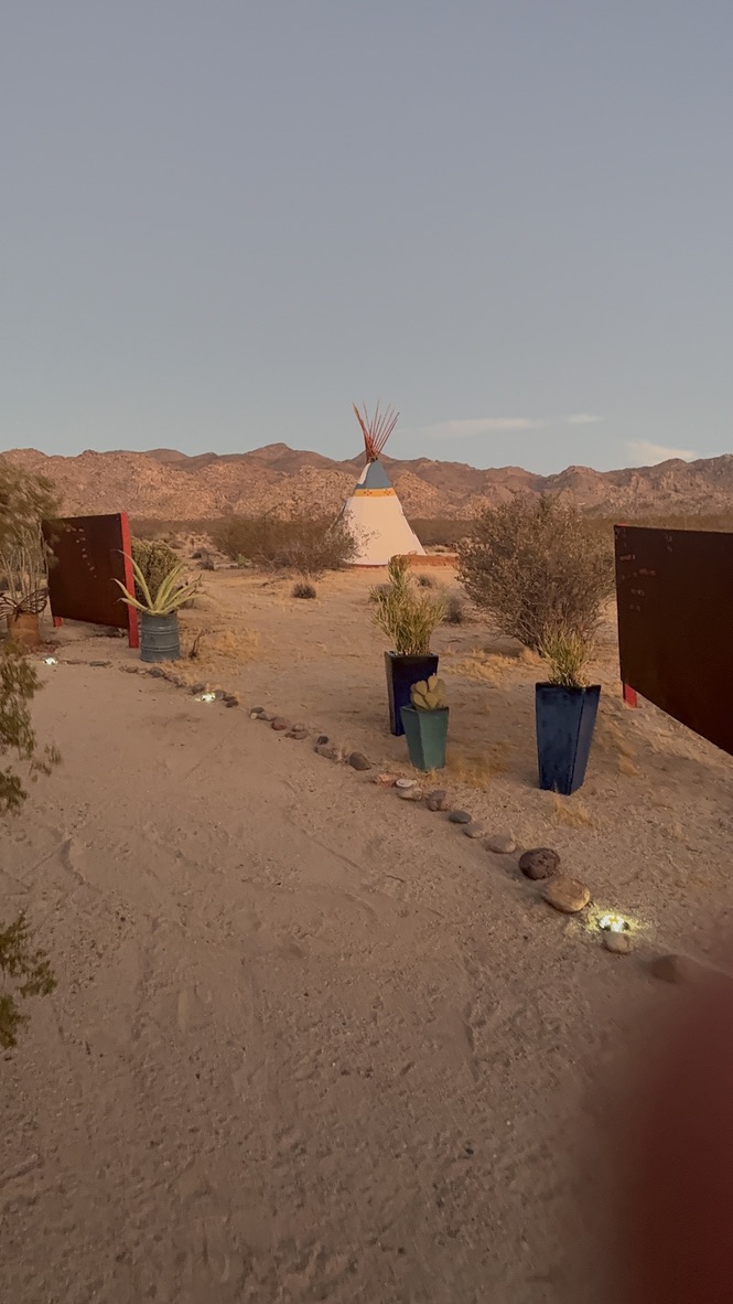 Teepee on the medicine wheel land with mountains beyond